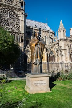 Pope John Paul II statue on side of church Notre Dame of Paris, France.