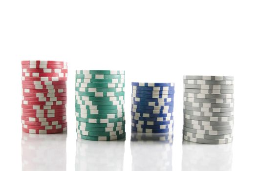 Stack of poker chips. Red,blue,green, and grey chips over white isolated background.