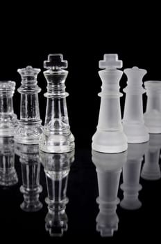 Chess pieces isolated on black background. Beautiful reflection composition