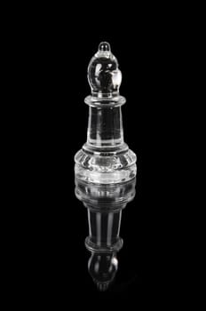 Glass chess bishop on black isolated background.