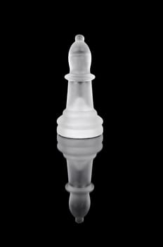 Glass chess bishop on black isolated background.
