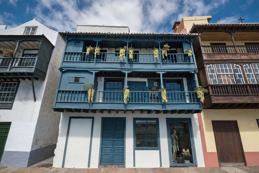 Famous ancient colorful colonies balconies decorated with flowers. Colonial houses facades in Santa Cruz, La Palma island in Spain