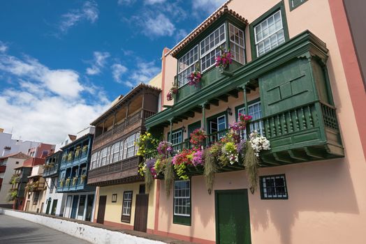 Famous ancient colorful colonies balconies decorated with flowers. Colonial houses facades in Santa Cruz, La Palma island in Spain