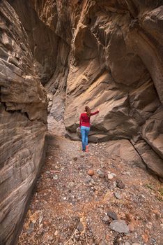 Young woman hiker in scenic canyon Barranco Bermeja, volcanic rock canyon in Tenerife, Canary islands, Spain.