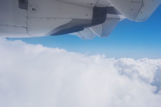 View of the clouds and the ocean from the airplane window.