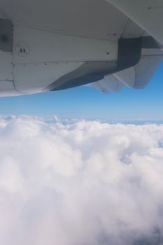 View of the clouds and the ocean from the airplane window.