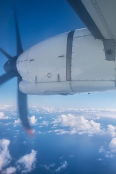 View of the clouds and the ocean from the airplane window.