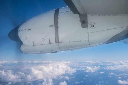 View of the clouds and the ocean from the airplane window.