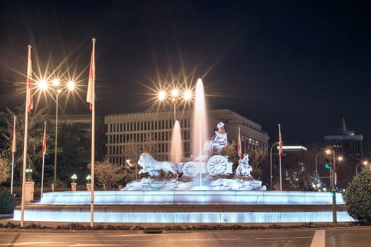 Famous landmark Cibeles fountain at night in Madrid, Spain.