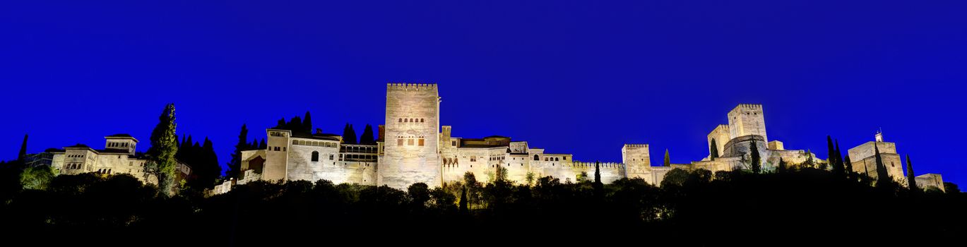GRANADA, SPAIN - APRIL 26:  Night Panorama during blue hour of the famous Alhambra palace on April 26, 2014 in Granada, Spain. This ancient arabic fortress is one of the most visited places of Andalusia, Spain.