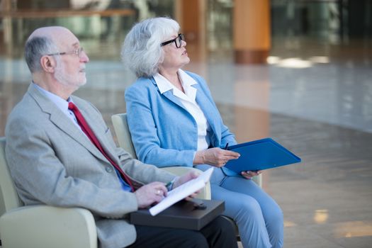 Senior couple meeting real estate agent. Senior couple meeting financial advisor for investment. Happy mature man and woman listening to various investment plans for their retirement.