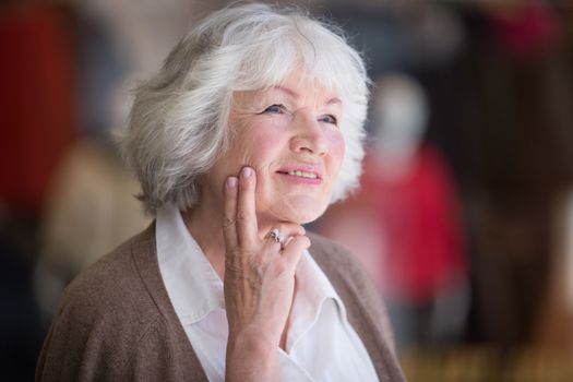 Portrait of nice smilig thoughtful senior woman close up