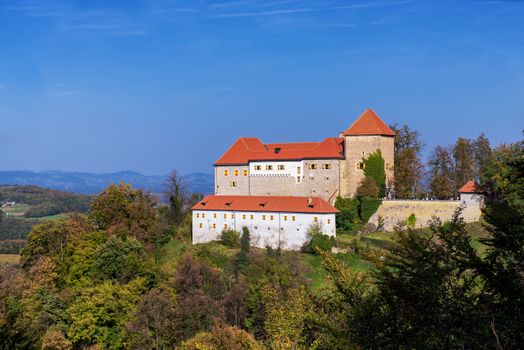 Medieval castle on top of hill, forests and hills in background. Podsreda, Slovenia, the castle is publicly owned and accesible, no release required for exterior