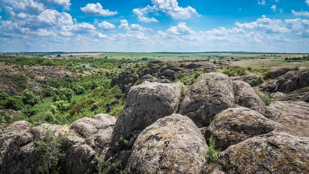 Panoramic view of deep granite Aktovo canyon with river and cloudy sky, One of the natural wonders of Ukraine.