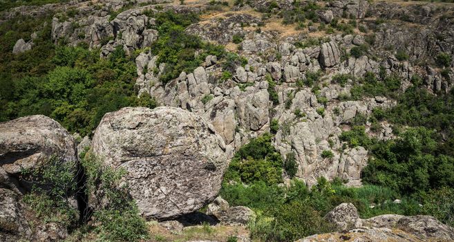 Panoramic view of deep granite Aktovo canyon with river and cloudy sky, One of the natural wonders of Ukraine.