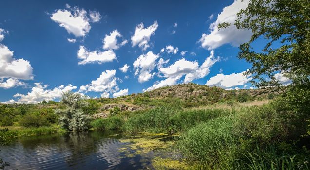 Panoramic view of deep granite Aktovo canyon with river and cloudy sky, One of the natural wonders of Ukraine.