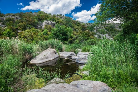 Panoramic view of deep granite Aktovo canyon with river and cloudy sky, One of the natural wonders of Ukraine.