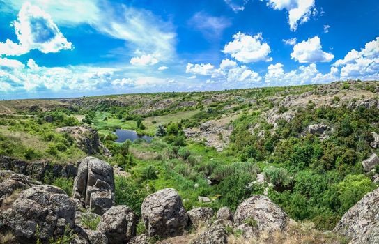 Panoramic view of deep granite Aktovo canyon with river and cloudy sky, One of the natural wonders of Ukraine.