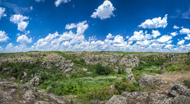 Panoramic view of deep granite Aktovo canyon with river and cloudy sky, One of the natural wonders of Ukraine.