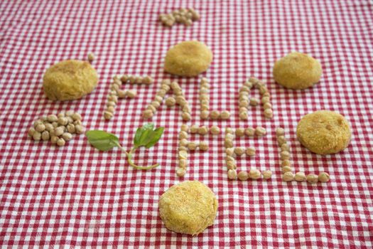 fried vegetarian falafel with near its written made with chickpeas