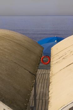 colors at sea with bathing hut beach umbrella and lifejacket