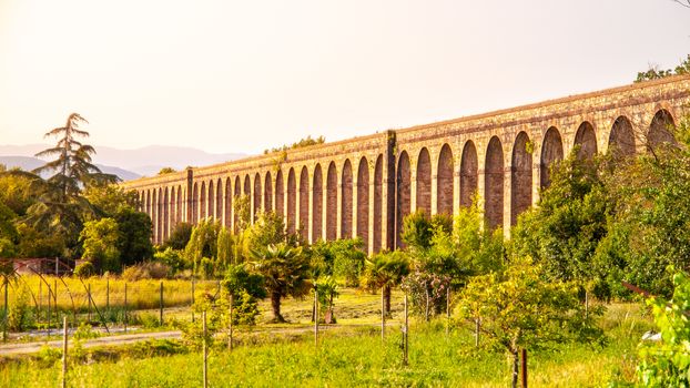 Sunny evening at Nottolini Aqueduct near Lucca, Tuscan, Italy.
