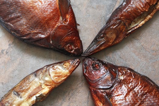 Closeup of few freshness smoked fishes on stone background