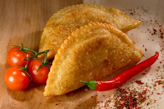 Cheburek - fried pie with meat and onions. Traditional dish of many turkic and mongolian peoples. Tomato juice.