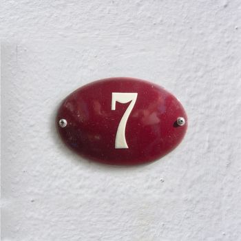 Enameled house number seven (7)
