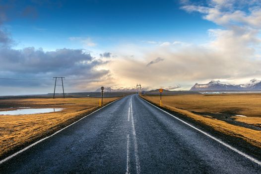 A long straight road and blue sky, Iceland.