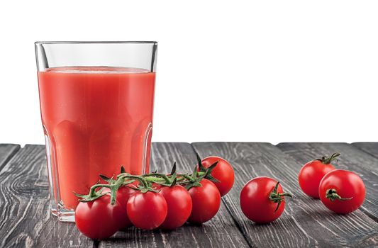 Cherry tomatoes and tomato juice. Dark wooden table isolated on white background.