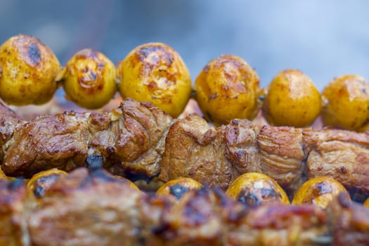 Barbecue kebab cooking. Tasty grill potatoes dinner cook. Food BBQ background. Roasted fresh beef meat