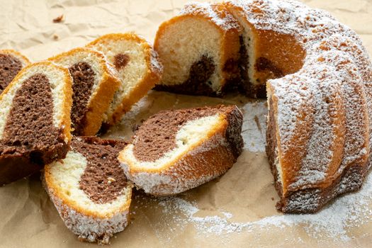 Traditional homemade marble cake. Sliced marble bundt cake on paper.