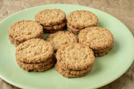 Tasty cookies biscuits. Stack of sugar cookies biscuits in green plate.