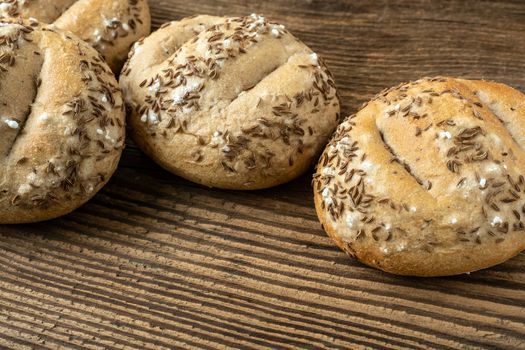 Bread rolls sprinkled with salt and caraway. Bakery assortment of bread.