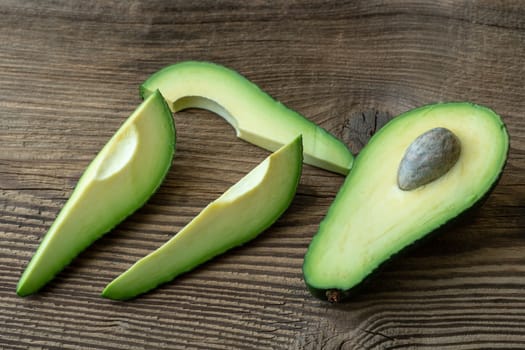 Fresh organic avocado on old wooden table. Avocado on a wooden background.