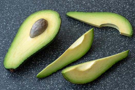 Fresh organic avocado on black background