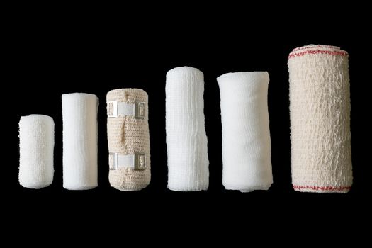 Different sizes of medical bandages. Medical bandages isolated on black background. Medical equipment.