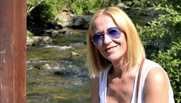 Andorra model sitting at the foot of the river resting from his walk