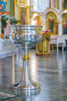 Orthodox bowl of holy water and candles for christening. Moldova