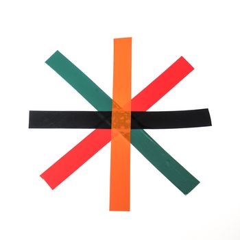 some strips of colored insulating tape cross over a white surface