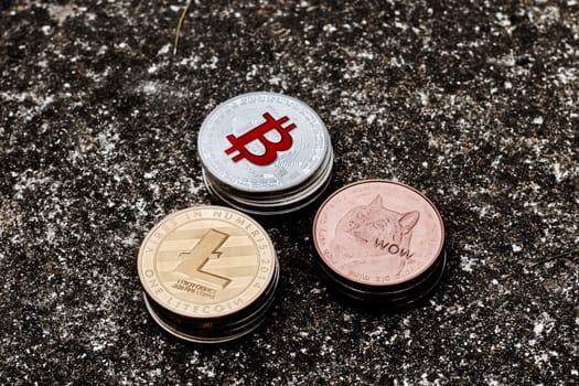 Digital currency physical bitcoin coin on the dark background. Dogecoin, Litecoin.