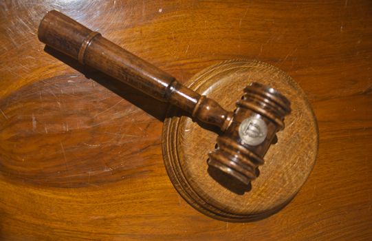 Judge courtroom gavel on wooden table, closeup