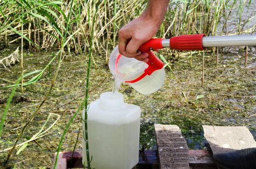 Take samples of water for laboratory testing. The concept - analysis of water purity, environment, ecology