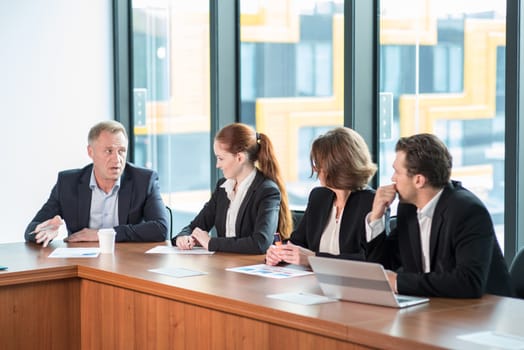 Image of business partners discussing documents and ideas at meeting