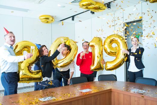 Business people celebrating 2019 New Year at office party