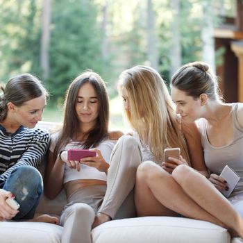 Portrait of girls chatting with their smartphones outdoors