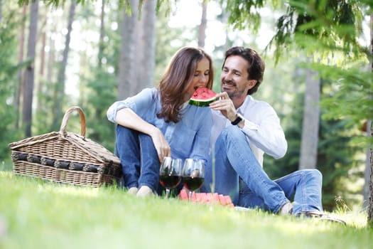 Young beautiful couple on picnic in summer park