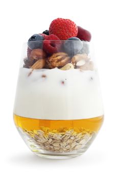 Breakfast smoothie ingredients in glass, cooking making concept, isolated on white background. Milkshake. Protein diet. Healthy food concept. Drink, oat flakes, milk, yoghurt, honey, nuts, berries