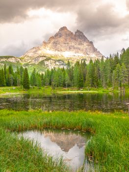 Tre Cime di Lavaredo Mountain reflected in water od Antorno Lake, Dolomites, Italy.